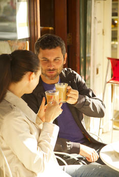 Couple at Outdoor Cafe Having Coffee
