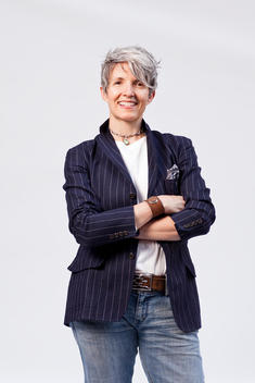 Caucasian Woman 50-60 Years Old In Jeans And Striped Blazer, Full Body Studio Portrait On White Background