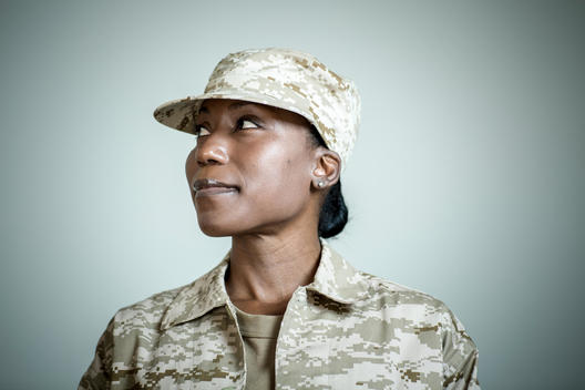 Studio portrait of confident female soldier looking sideways
