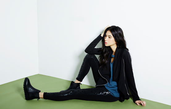 A fashion image of a girl sitting on the floor