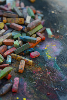 Multicolored chalk in rain makes colorful abstract design