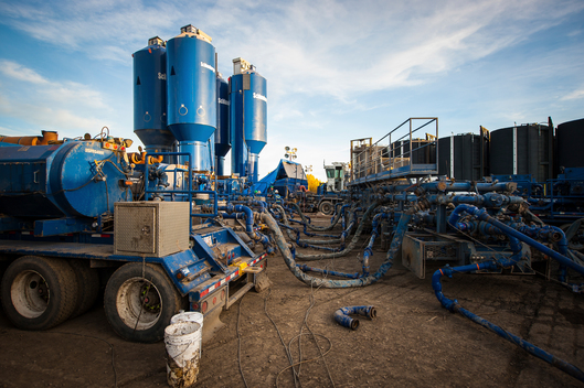 Trucks with liquefied natural gas hydraulic fracturing (fracking) fluid material ready to mix.
