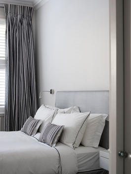Coordinated striped fabric in double bedroom in Chesilton Road home, UK