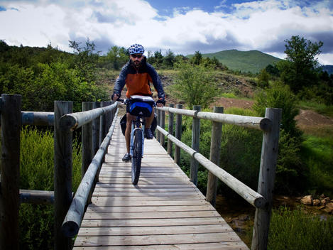 transpyrenean bike route. Crossing the wood bridge in Huesca