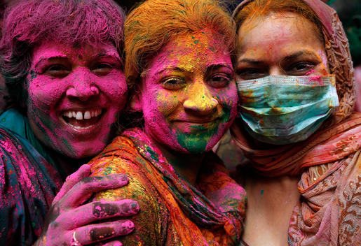 India, Uttar Pradesh, Vrindavan, three women during Holi, spring festival, festival of colours