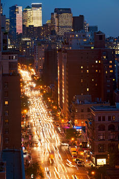 Night View From A Roof Of Brightly Lit Sky Scrapers And Streaming Traffic Along Sixth Avenue. New York, New York.