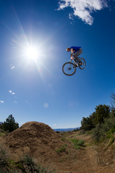 Male mountain biker jumping in the air on his mountain bike.