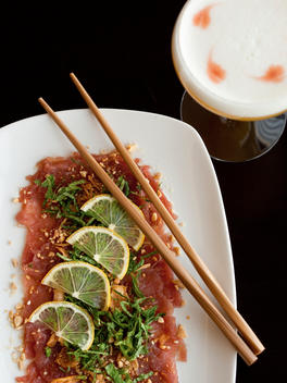 Vietnamese Tuna Carpaccio On White Plate And Black Backgorund With Cocktail.