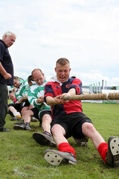 Men and women competing in a tug of war contest at Bakewell Show, one of the oldest agricultural shows in the UK.