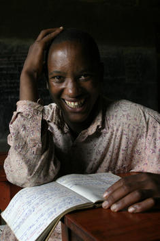 Emmanwel Kamari, born 1987. Young student with his text book at a school in Rwanda, East Africa. African children studying. African school. 10th anniversary of the Rwandan Genocide, April 2004. Part of their education includes 'civil liberties' classes wh