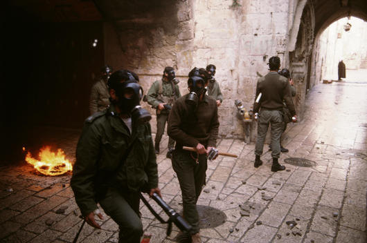 Jerusalem, Israel January 15, 1988 More then 1,000 Israeli soldiers surround and enter the Dome of the Rock as Palestinian shout anti-Israeli slogans and burn Israeli and American flags after Friday ceremonies. Israel soldiers shoot tear gas into the Dome