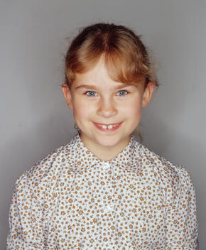 Portrait Of Awkward Young Girl In Floral Blouse