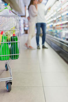 Defocussed view of couple shopping together in grocery store