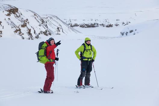 Backcountry skiers discuss ski objectives in Foxdalen, Svalbard.