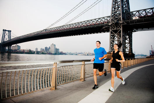 Two Runners On East River Path Near Williamsburg Bridge.