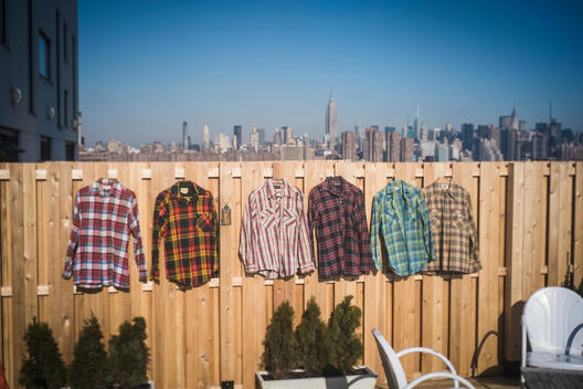 Flannel shirts hanging to dry in urban backyard, New York, New York, United States