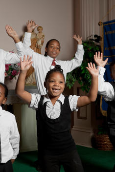 Group Of Children Of African-American Appearance Catholic Church Smiling And Having Fun During Choir Practice