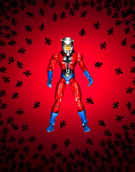 Ant Man figurine on ant and red background