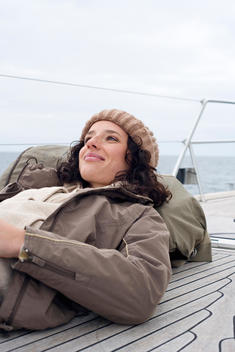 Germany, Baltic Sea, L?becker Bucht, Young woman lying on deck of yacht, portrait