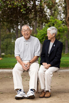 Older Asian couple smiling together outdoors