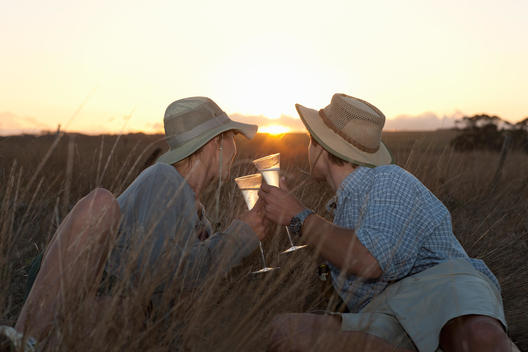 Couple drinking wine on safari, Stellenbosch, South Africa