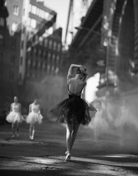 Dancers in black and white near bridge