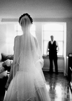 Young bride and father looking at each other