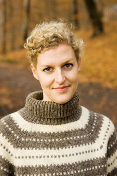 Portrait Of A Blonde Woman Wearing A Patterned Sweater
