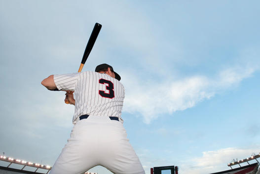 Baseball player preparing to bat, rear view