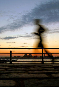 Motion Blur Of Jogger At Sunset