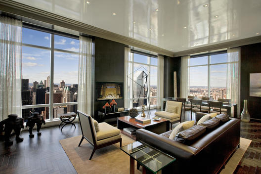 Penthouse Floor Living Room With Leather Couch, Crown Molding, Dining Table And Sculptures