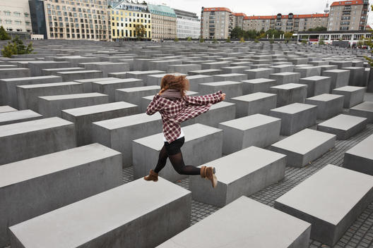 Girl Jumping On Holocaust Memorial, Berlin, Germany