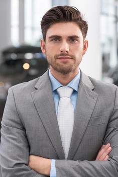 At the car dealer, Portrait of confident salesman