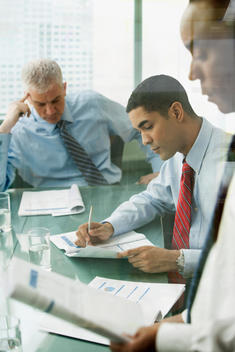 Business people reviewing paperwork in meeting