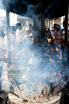 Buddhists Praying And Offering Incense Sticks At The Temple Of The Sacred Tooth, Kandy, Sri Lanka.