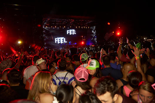 A crowd in neon gear at a rave.