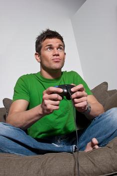 A Fraternity Guy Playing Video Games On A Couch.