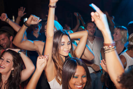 Crowd dancing on dance floor of nightclub