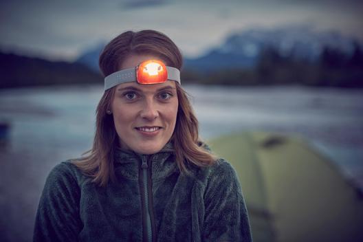 Portrait of young woman wearing headlamp, looking at camera