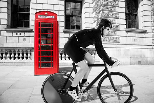 Cyclist Cycling Past Red Telephone Box