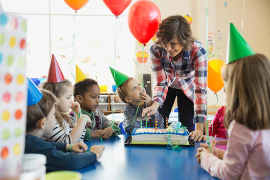 Teacher and kids celebrating birthday in school