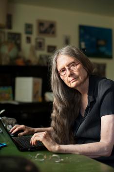 Portrait of elderly woman with laptop