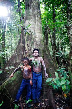 Hispanic boys with painted body in jungle, Lago Izabal, Guatemala