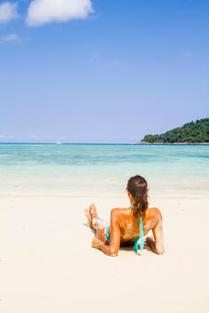 Thailand, Koh Surin island, woman lying at white sandy beach