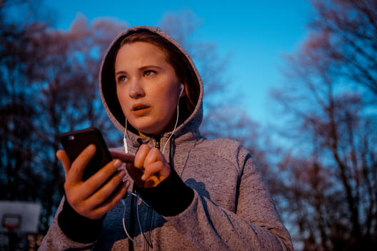 Woman choosing music for her winter workout