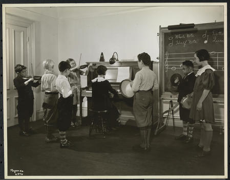 Visually Impaired/Blind Children At The Clinic Of The New York Association For The Blind, 114 East 60Th Street With Children Playing Musical Instruments--Piano, Tambourine, Triangle, Symbols, Violins.