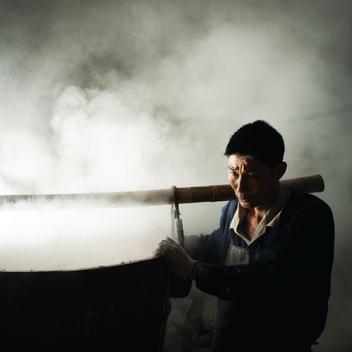 Workers steam rice for rice wine making at the Zhejiang Pagoda Brand Shaoxing Rice Wine Co., Ltd in Shaoxing, China on Tuesday, November 8, 2016. The Zhejiang Pagoda Brand uses water from the nearby Mirror Lake which contains mountain spring water for a p