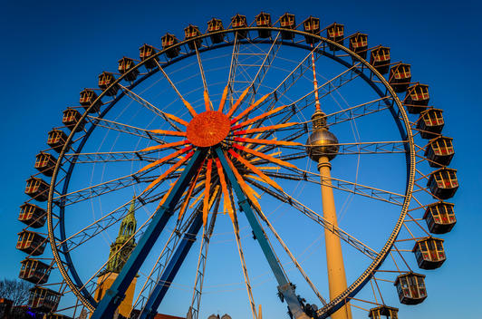 Ferris wheel and towers under blue sky