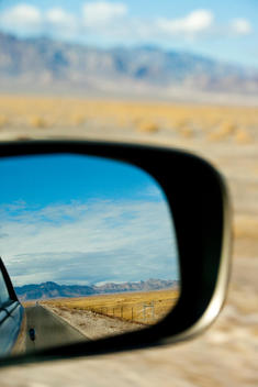 A car driving through the desert landscape