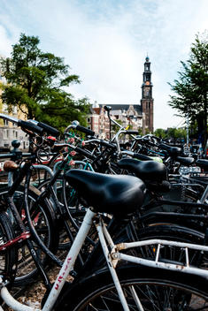A mass of bicycles sits locked in front of Westerkerk church in Amsterdam.